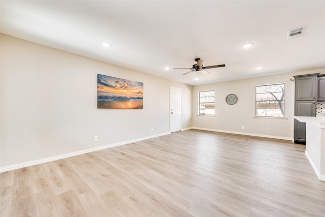 unfurnished living room with ceiling fan and light wood-type flooring