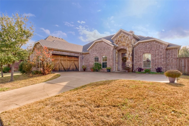 front of property featuring a front lawn and a garage