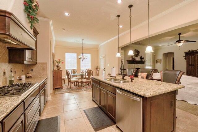 carpeted living room with a fireplace, ceiling fan, and ornamental molding