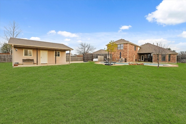 view of yard with a patio area and a fenced in pool