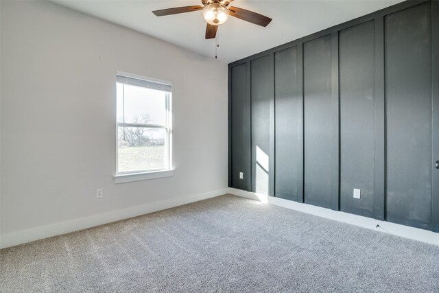 spare room with carpet flooring and ceiling fan