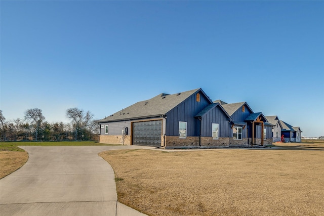 view of front of house with a garage and a front yard