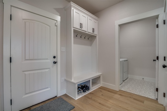 mudroom featuring independent washer and dryer and light hardwood / wood-style flooring