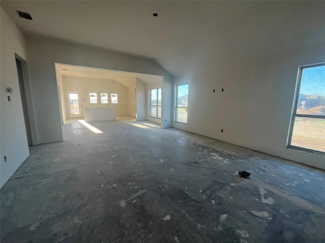 unfurnished living room featuring lofted ceiling