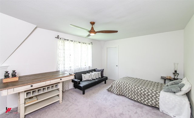 bedroom featuring ceiling fan and carpet