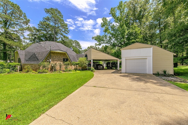 view of front of house with an outbuilding, a garage, a front lawn, and a carport