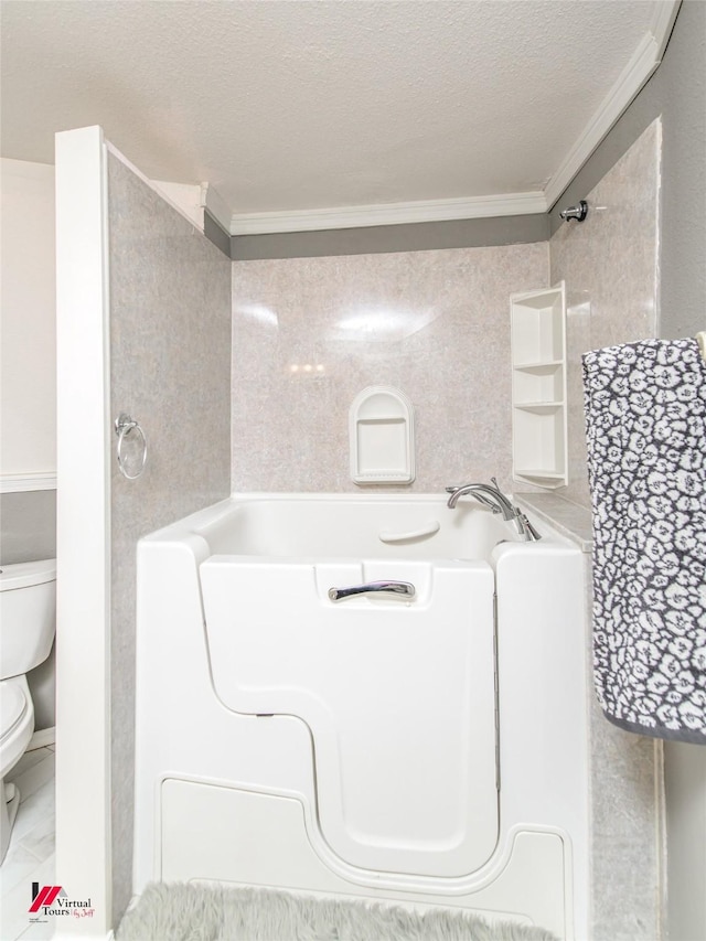 bathroom featuring crown molding, a tub to relax in, a textured ceiling, and toilet