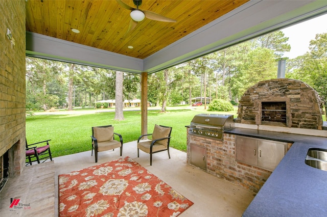 view of patio with a grill, sink, exterior fireplace, and exterior kitchen