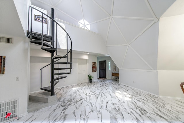 staircase featuring high vaulted ceiling