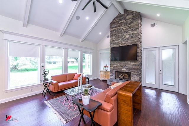 living room featuring beam ceiling, a stone fireplace, dark wood-type flooring, and high vaulted ceiling