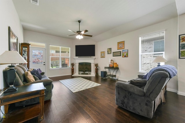 living room with ceiling fan, lofted ceiling, and dark hardwood / wood-style flooring