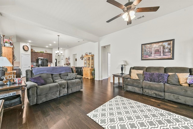 living room with dark hardwood / wood-style flooring, beamed ceiling, and ceiling fan with notable chandelier