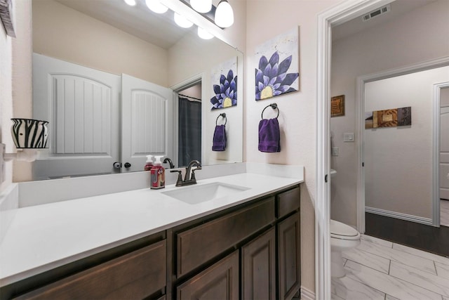 bathroom with vanity and toilet