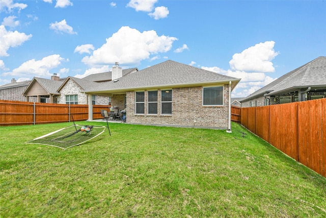 rear view of house featuring a patio and a lawn