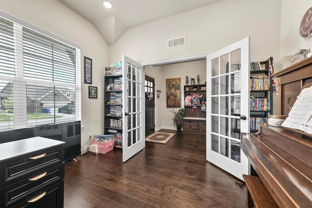 home office with lofted ceiling, dark wood-type flooring, and french doors