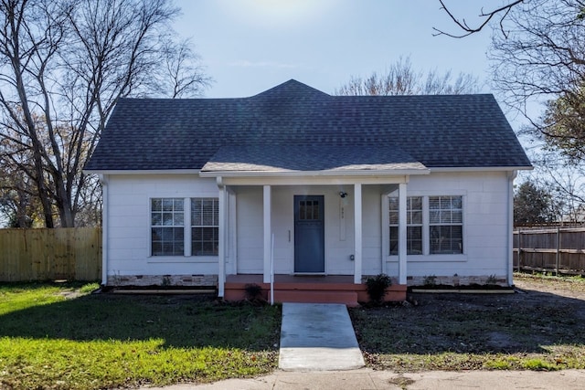 bungalow with covered porch and a front lawn