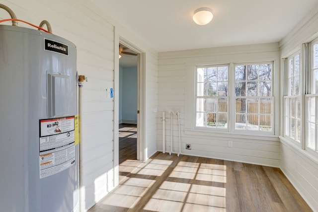 unfurnished sunroom featuring water heater