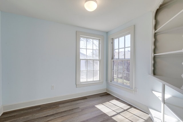 unfurnished room featuring hardwood / wood-style floors