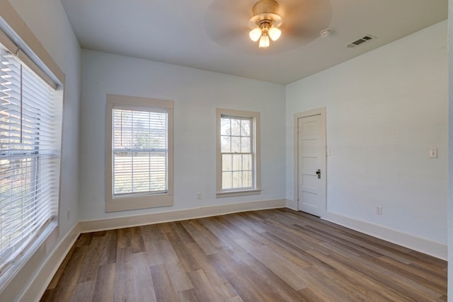 spare room with ceiling fan and wood-type flooring