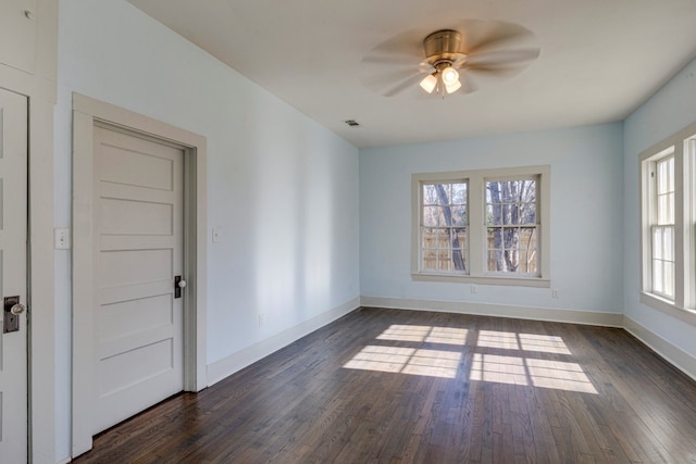 unfurnished room with dark hardwood / wood-style floors and ceiling fan