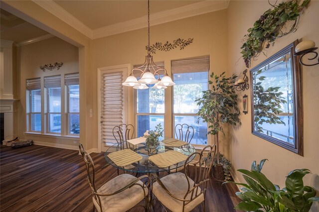 dining area featuring ornamental molding, wood-type flooring, and a chandelier