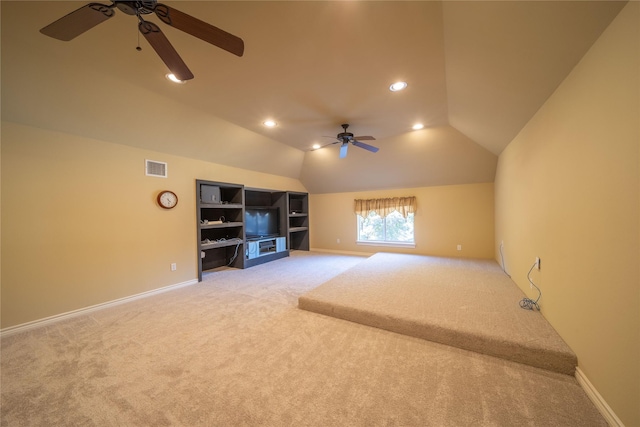 unfurnished living room featuring ceiling fan, light colored carpet, and vaulted ceiling