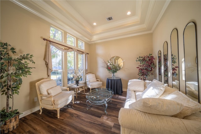 living area featuring dark hardwood / wood-style floors, a tray ceiling, and crown molding