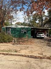 view of front of property featuring a carport