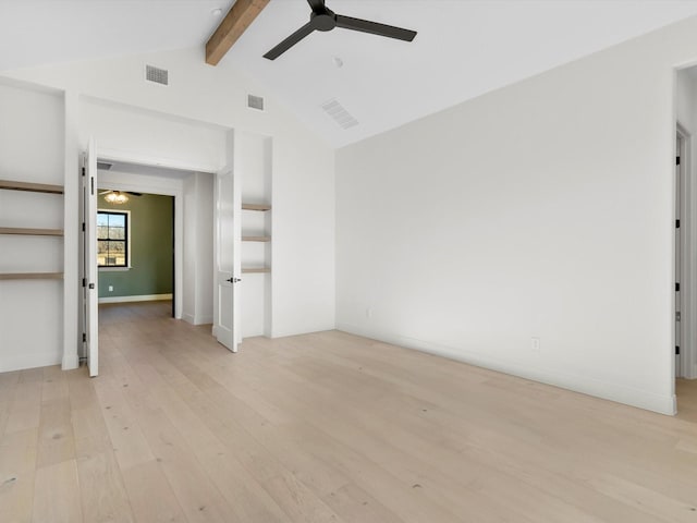 unfurnished room with vaulted ceiling with beams and light hardwood / wood-style floors