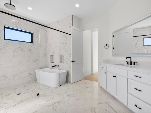 bathroom with vanity and shower with separate bathtub