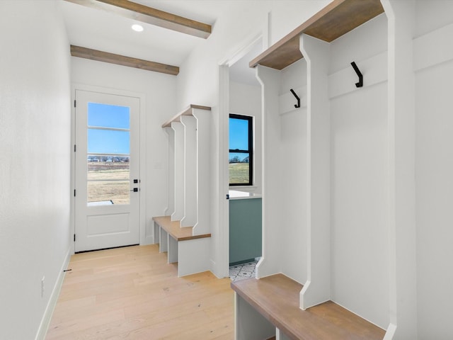 mudroom with beamed ceiling and light wood-type flooring