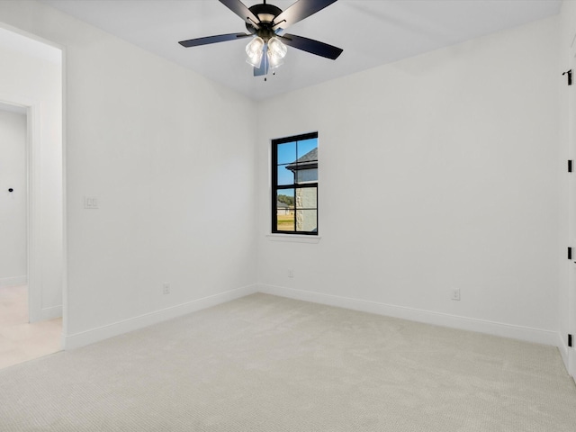 empty room with ceiling fan and light colored carpet