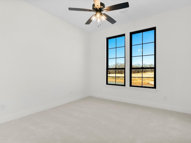 carpeted spare room with ceiling fan