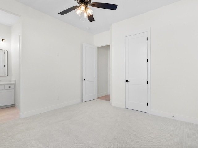 unfurnished bedroom featuring connected bathroom, ceiling fan, and light carpet