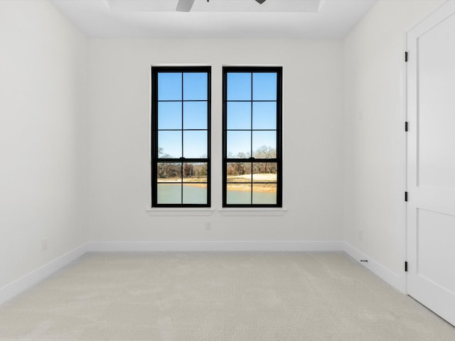 carpeted spare room with ceiling fan