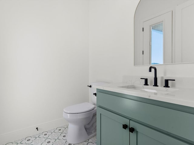 bathroom with tile patterned floors, vanity, and toilet