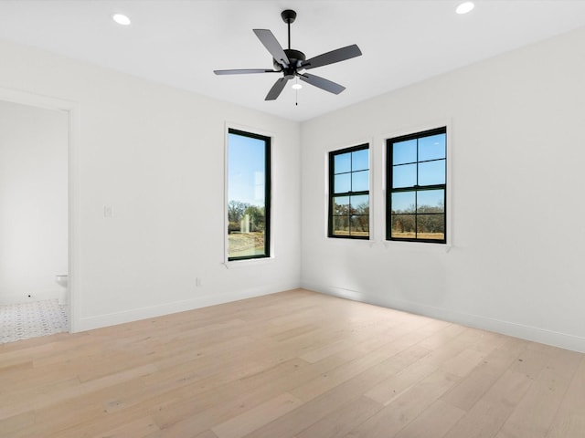 unfurnished room featuring ceiling fan and light wood-type flooring