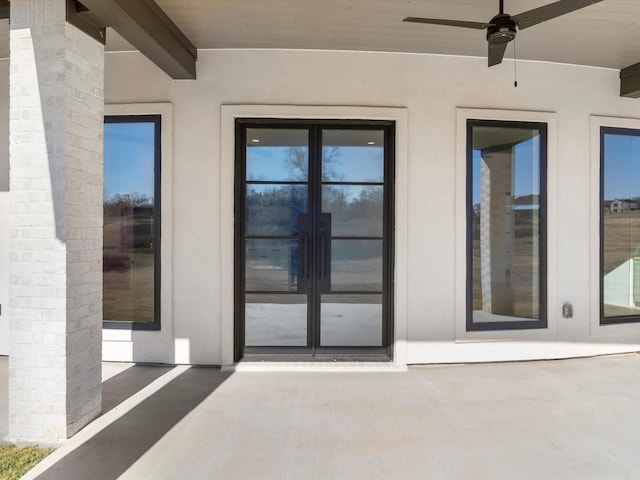 doorway to property with a patio area, ceiling fan, and french doors