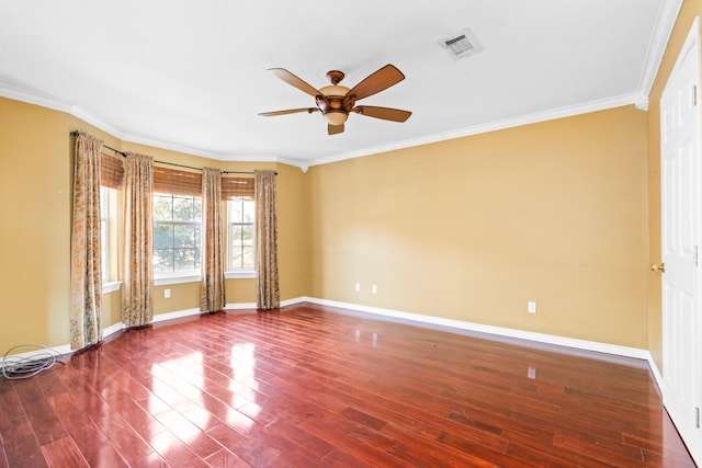 empty room with ceiling fan, dark hardwood / wood-style flooring, and crown molding