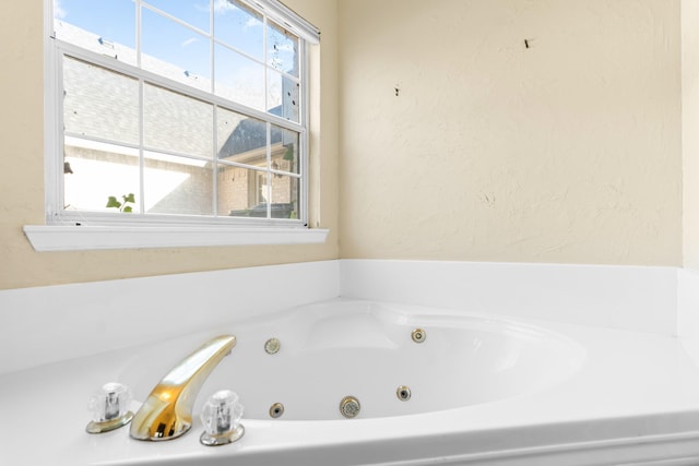 bathroom with a tub to relax in