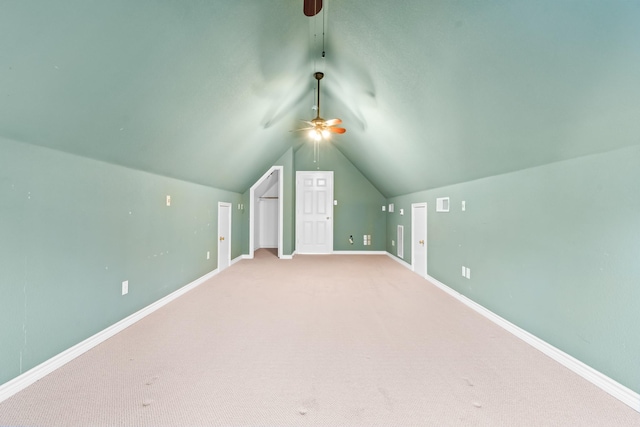 additional living space featuring ceiling fan, light colored carpet, and vaulted ceiling