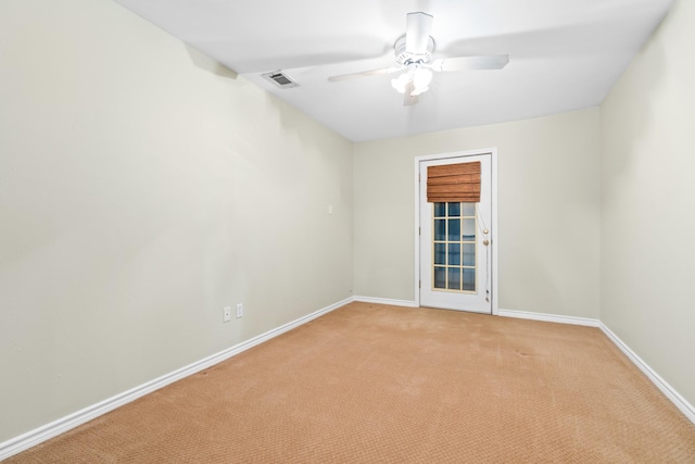 carpeted spare room with ceiling fan