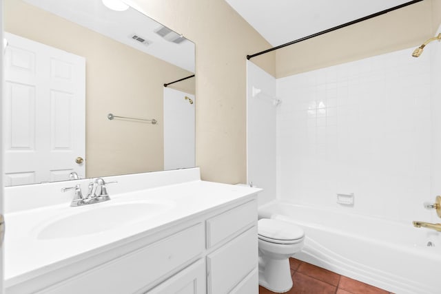 full bathroom featuring tile patterned flooring, vanity, tiled shower / bath, and toilet