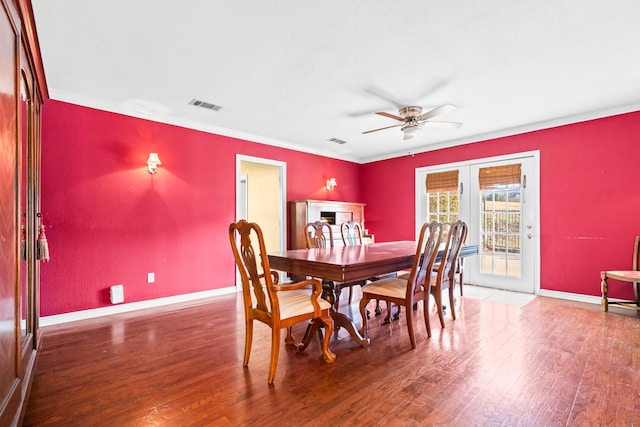 dining area with crown molding, ceiling fan, and dark wood-type flooring