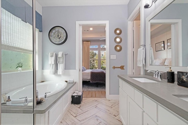 bathroom featuring vanity and a relaxing tiled tub