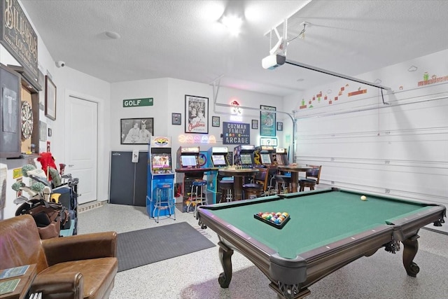 playroom with a textured ceiling and billiards