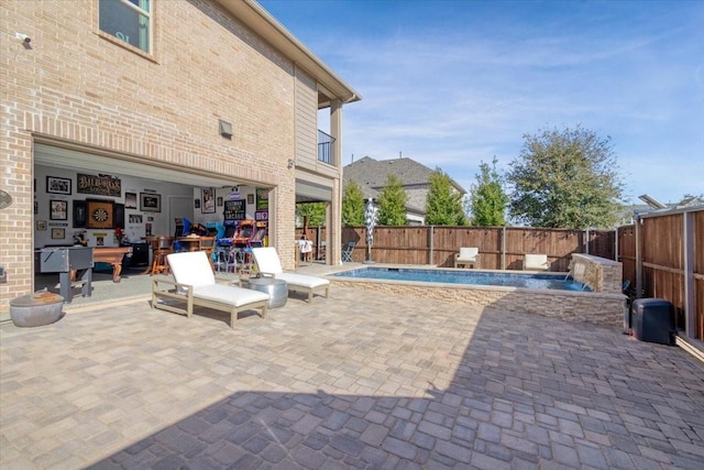 view of swimming pool featuring pool water feature and a patio area