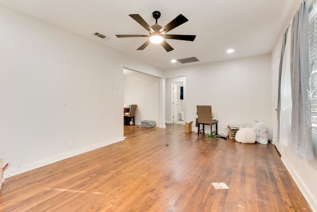 empty room with hardwood / wood-style floors and ceiling fan