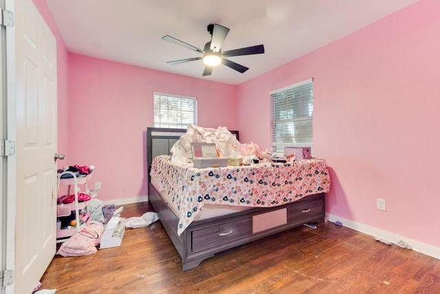 bedroom with ceiling fan and dark hardwood / wood-style flooring