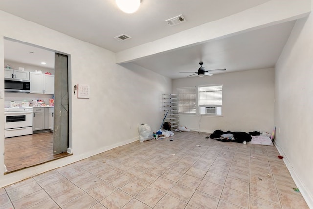 interior space featuring cooling unit, ceiling fan, and light tile patterned floors